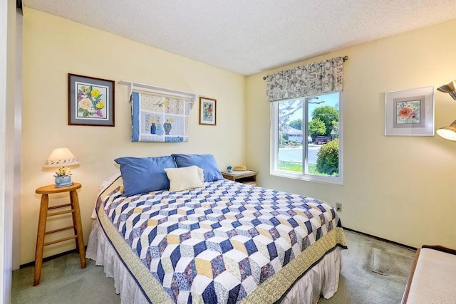 carpeted bedroom featuring a textured ceiling and baseboards