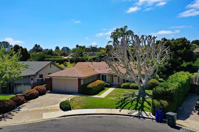 ranch-style house with an attached garage, driveway, fence, and a front lawn