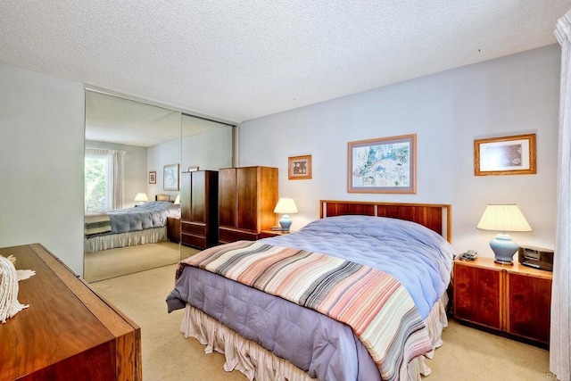 carpeted bedroom featuring a closet and a textured ceiling