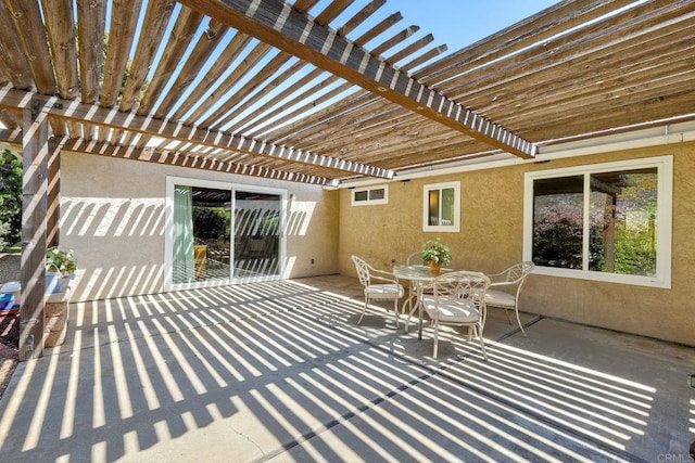view of patio with a pergola and outdoor dining space