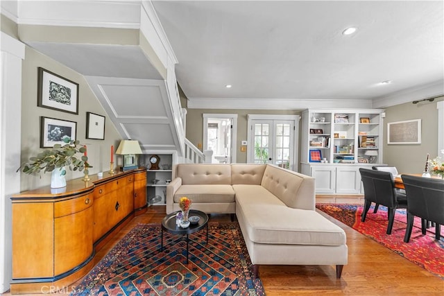 living room featuring crown molding, recessed lighting, french doors, and wood finished floors