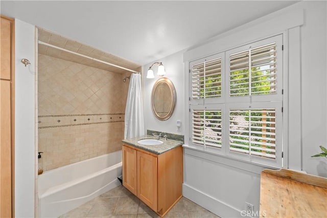 full bath featuring vanity, shower / bathtub combination with curtain, and tile patterned floors