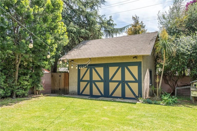 view of shed featuring fence