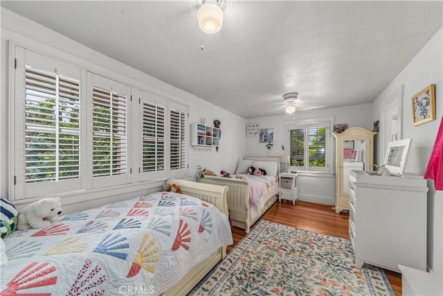 bedroom featuring wood finished floors and a ceiling fan
