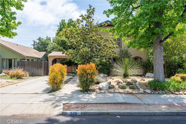 exterior space with stucco siding and fence