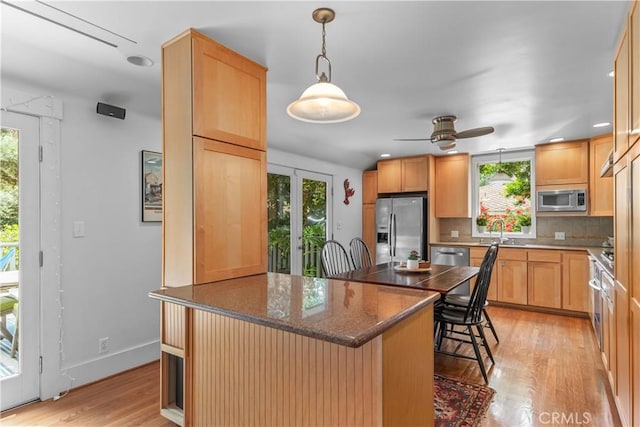 kitchen featuring plenty of natural light, stainless steel appliances, and a sink