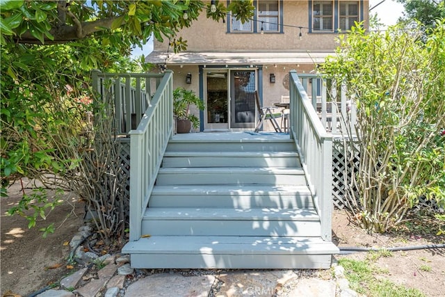 doorway to property with stucco siding