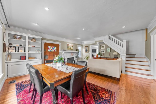 dining area with stairs, ornamental molding, visible vents, recessed lighting, and light wood finished floors