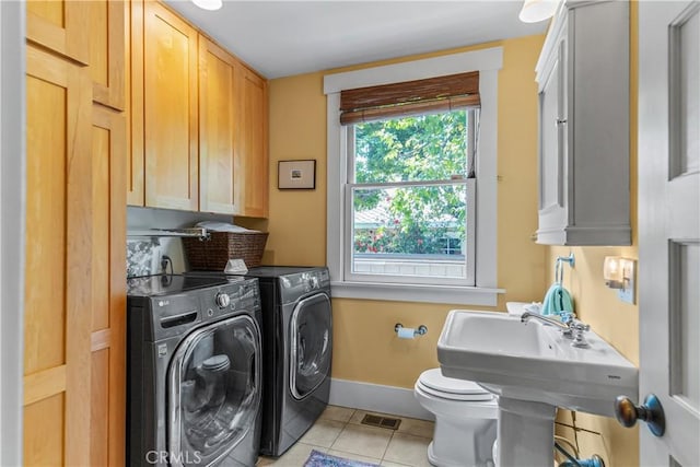 laundry area featuring independent washer and dryer, laundry area, visible vents, light tile patterned floors, and baseboards