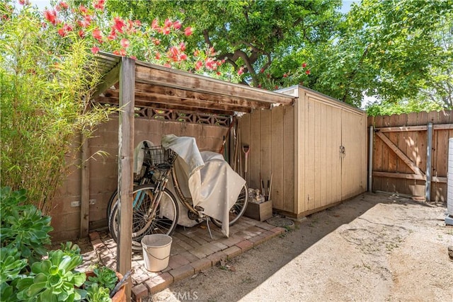 view of outbuilding with a gate and fence