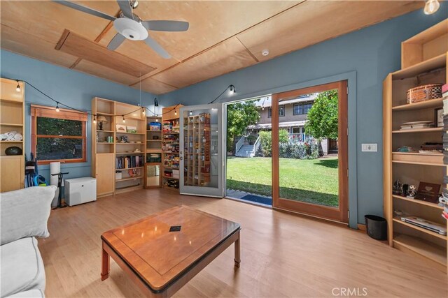 living area with ceiling fan and wood finished floors