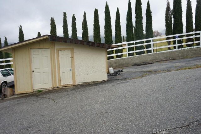 view of shed with fence