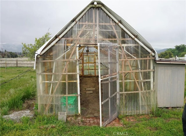 view of greenhouse with fence