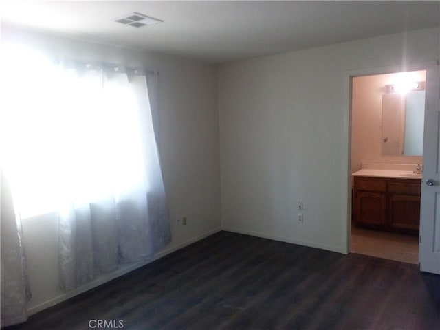 23171 Woodford Tehachapi Rd, Tehachapi, CA 93561 - empty room with dark wood finished floors and a sink