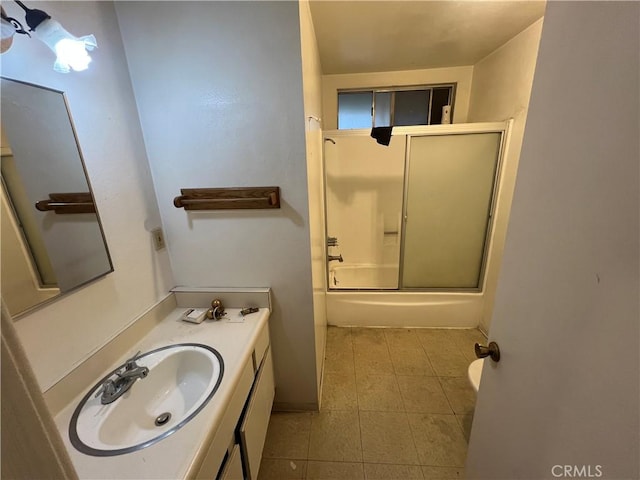 full bathroom featuring tile patterned floors, vanity, and shower / bath combination with glass door