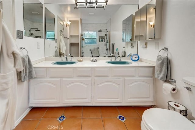 full bathroom with a sink, tile patterned flooring, toilet, and a shower stall