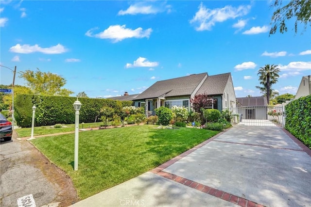 single story home with a gate, concrete driveway, fence, and a front yard