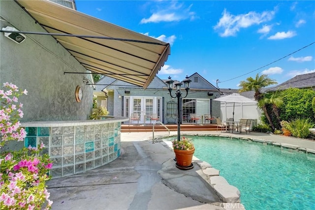 pool featuring a patio, french doors, and fence