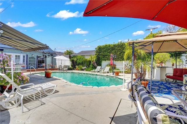 view of swimming pool featuring a patio and a fenced in pool