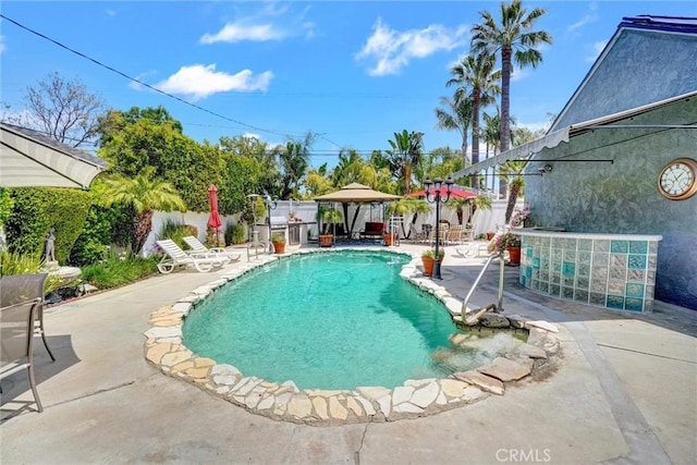 view of pool with a gazebo, a patio area, a fenced in pool, and fence