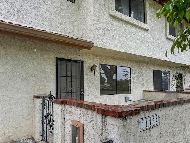 entrance to property featuring stucco siding