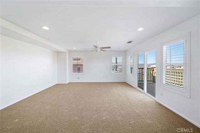 empty room with baseboards, recessed lighting, and light colored carpet