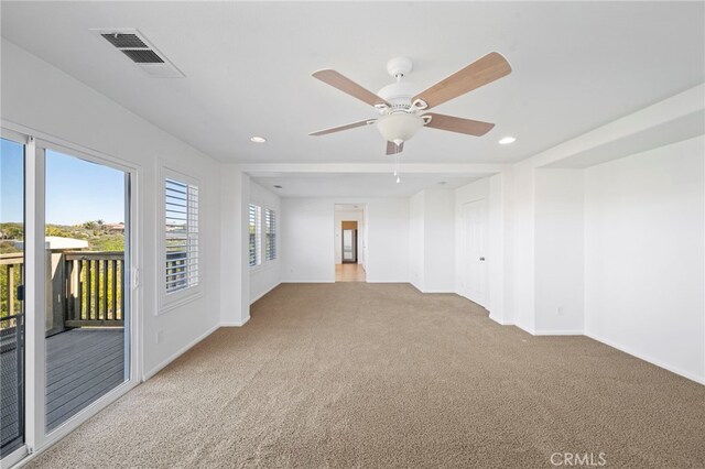 spare room with light colored carpet, baseboards, visible vents, and recessed lighting