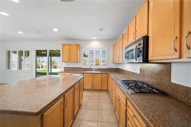 kitchen featuring recessed lighting, a healthy amount of sunlight, appliances with stainless steel finishes, and a sink