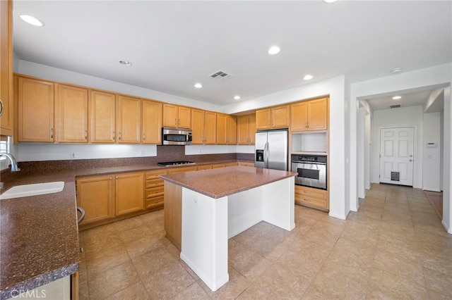 kitchen featuring recessed lighting, a center island, visible vents, a sink, and stainless steel appliances
