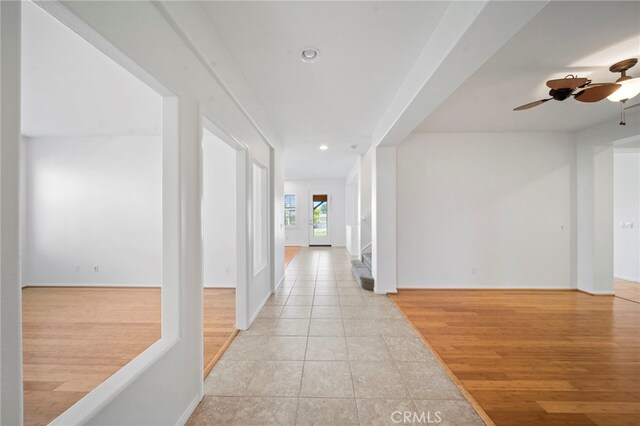 corridor with light tile patterned floors, recessed lighting, and baseboards