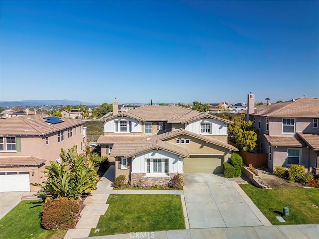traditional home with an attached garage, driveway, a residential view, and stone siding