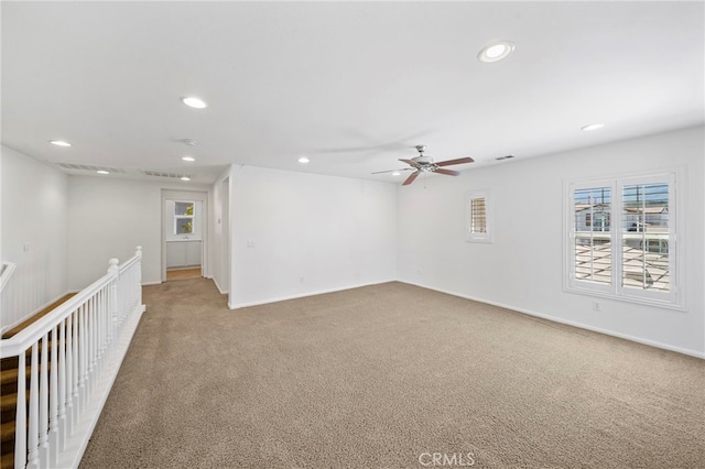 spare room featuring a wealth of natural light, light carpet, and recessed lighting
