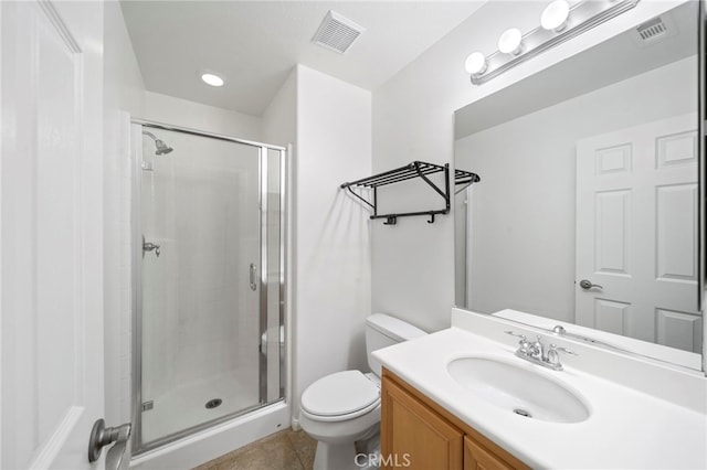 bathroom with a stall shower, toilet, and visible vents