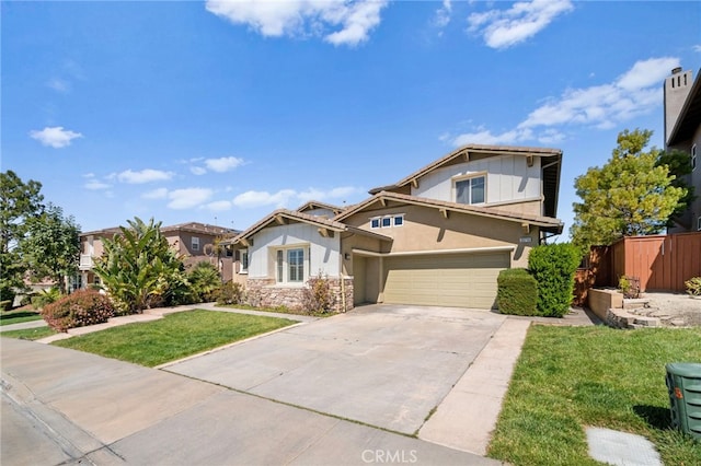 craftsman inspired home featuring a front yard, fence, stucco siding, concrete driveway, and stone siding