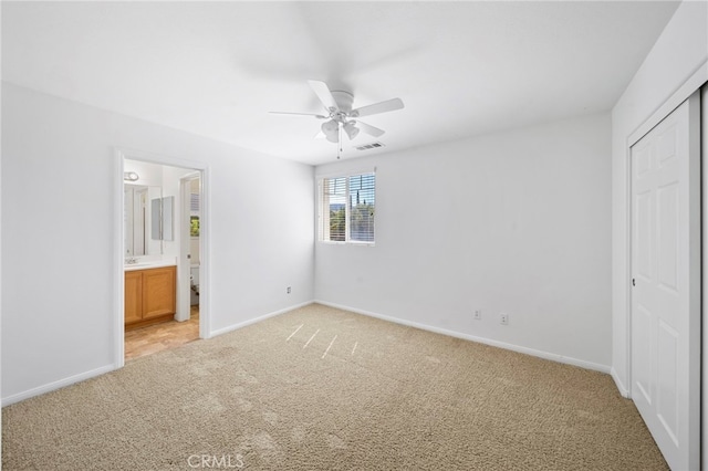 unfurnished bedroom featuring light colored carpet, visible vents, and baseboards