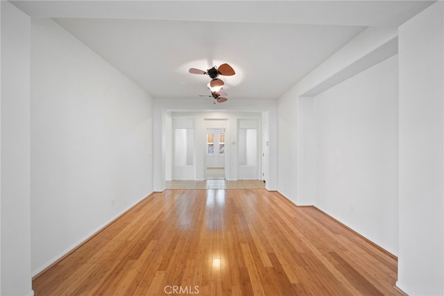 foyer entrance featuring light wood finished floors, baseboards, and ceiling fan