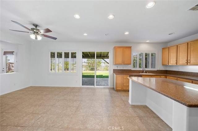 kitchen with plenty of natural light, recessed lighting, a sink, ceiling fan, and a center island