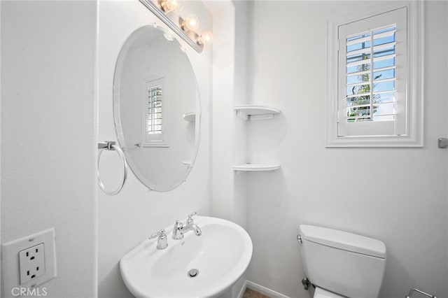 half bathroom with a sink and toilet