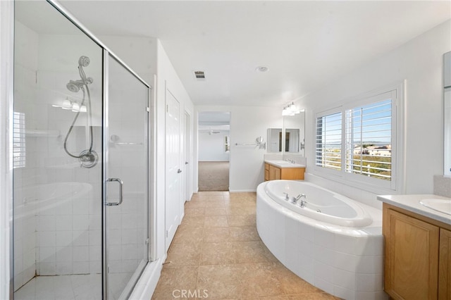 full bathroom featuring visible vents, a shower stall, tile patterned floors, a garden tub, and two vanities