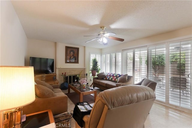 12592 Arlington Pl, Chino, CA 91710 - living room featuring a ceiling fan, a textured ceiling, and a tile fireplace