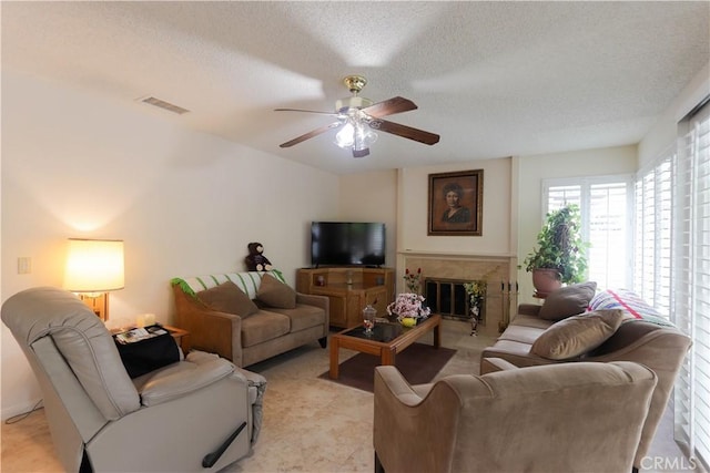 12592 Arlington Pl, Chino, CA 91710 - living room featuring a ceiling fan, a textured ceiling, and a glass covered fireplace
