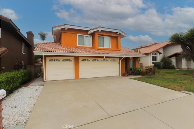 12592 Arlington Pl, Chino, CA 91710 - view of front of house featuring a tiled roof, concrete driveway, stucco siding, and an attached garage