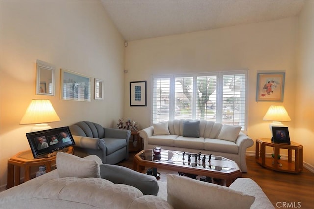 12592 Arlington Pl, Chino, CA 91710 - living room with dark wood finished floors, high vaulted ceiling, and baseboards