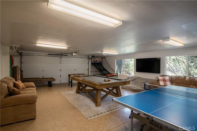 920 Oak Rd, Lake Arrowhead, CA 92385 - recreation room with a textured ceiling, a garage, and plenty of natural light