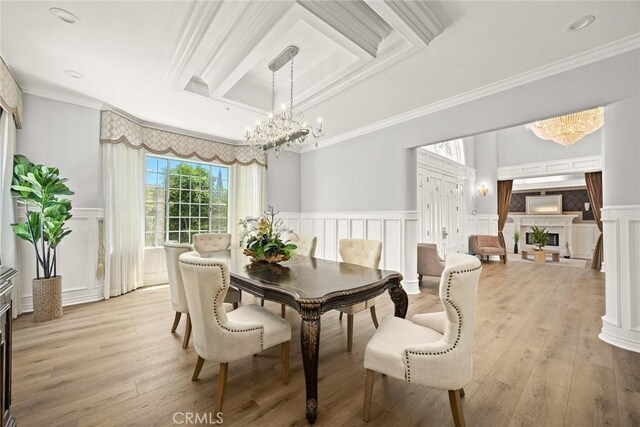 67 W Wistaria Ave, Arcadia, CA 91007 - dining room with a chandelier, a decorative wall, a fireplace, crown molding, and light wood-type flooring