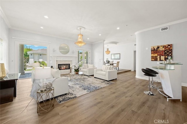 67 W Wistaria Ave, Arcadia, CA 91007 - living area featuring wood finished floors, crown molding, recessed lighting, a high end fireplace, and baseboards
