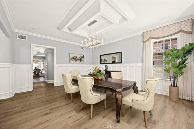 67 W Wistaria Ave, Arcadia, CA 91007 - dining room featuring a chandelier, wainscoting, light wood finished floors, crown molding, and a decorative wall