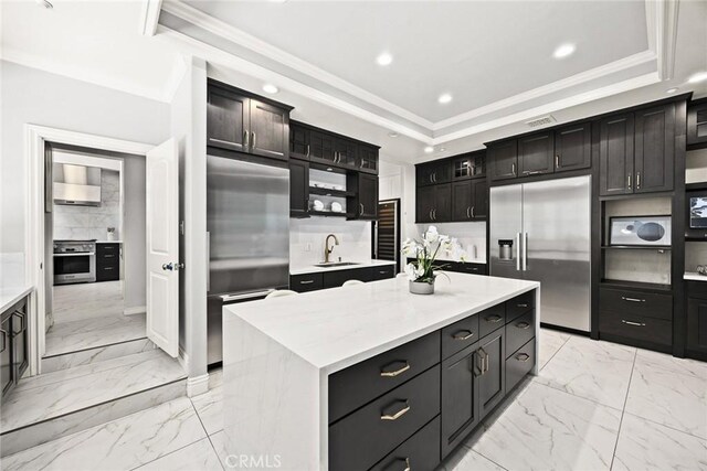 67 W Wistaria Ave, Arcadia, CA 91007 - kitchen with built in fridge, light marble finish flooring, high quality fridge, a raised ceiling, and ornamental molding