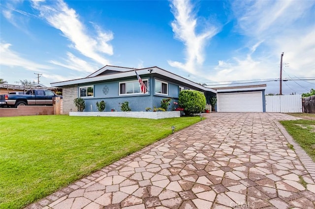 single story home featuring driveway, fence, a garage, stucco siding, and a front yard