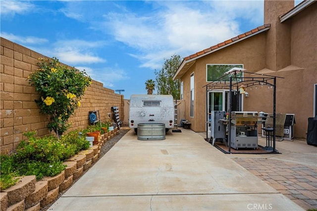 view of patio / terrace with a fenced backyard and a jacuzzi